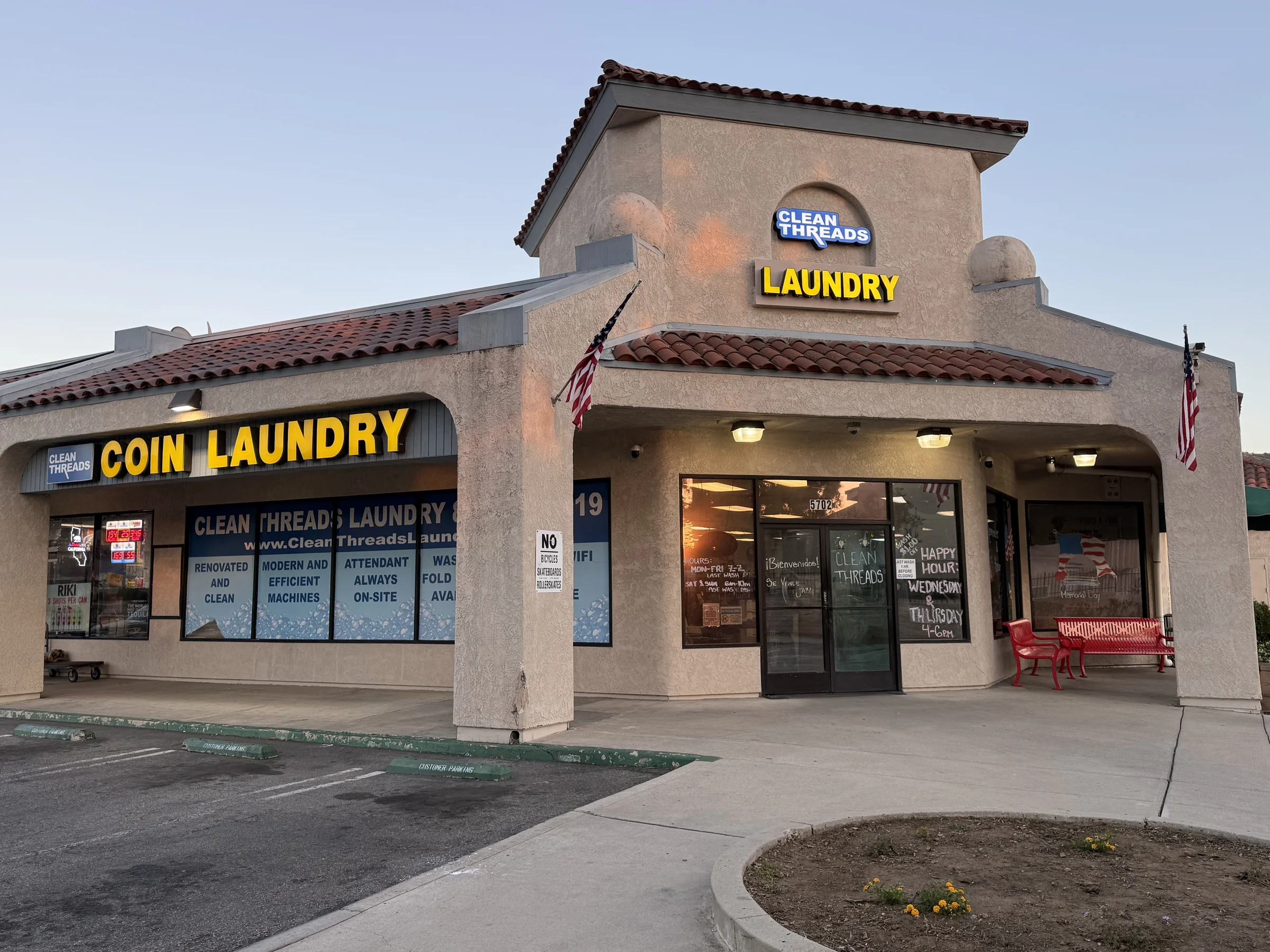 Clean Threads Laundry storefront lit at night